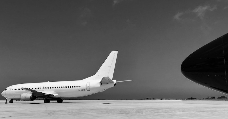 Airplane on tarmac in black and white.